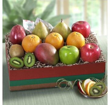 A box of fruit with apples, bananas and other fruits.