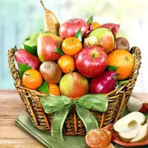 A basket of fruit with apples, oranges and pears.