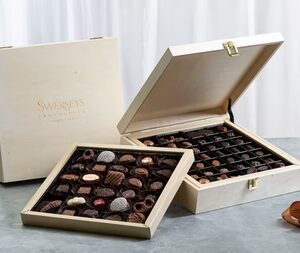 A couple of boxes filled with chocolates on top of a table.