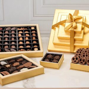 A table topped with boxes of chocolates and other treats.