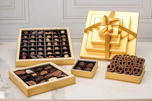 A table topped with boxes of chocolates and other treats.