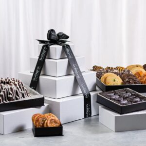 A table topped with boxes of different types of pastries.