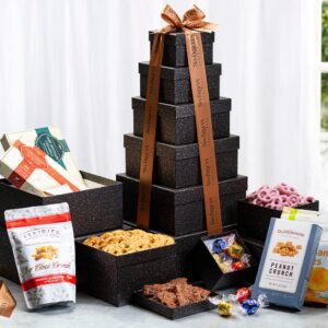 A tower of chocolate covered snacks on top of a table.