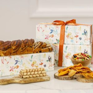 A table with two boxes of food and some cookies.