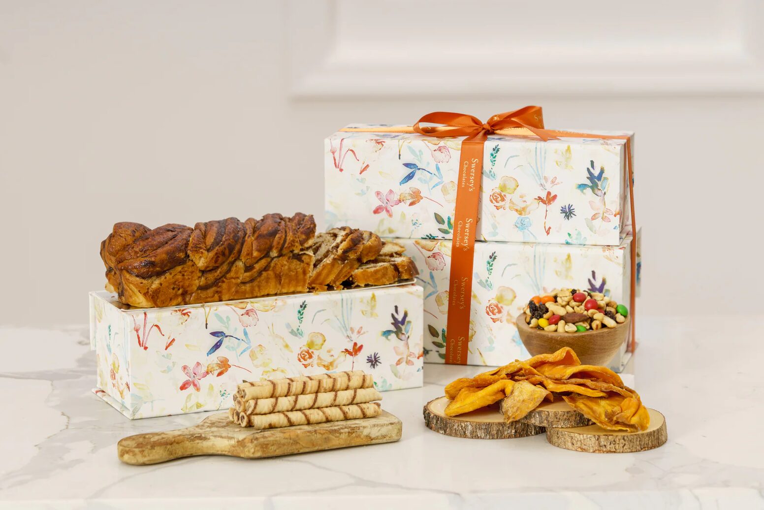 A table with two boxes of food and some cookies.