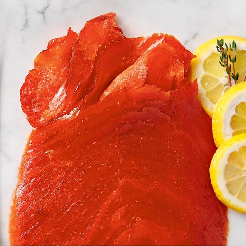 A plate of food with lemon and fish.