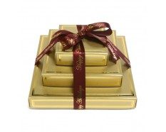 A stack of three gold boxes with ribbon.