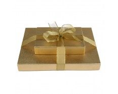 A gold gift box with a bow on top of it.